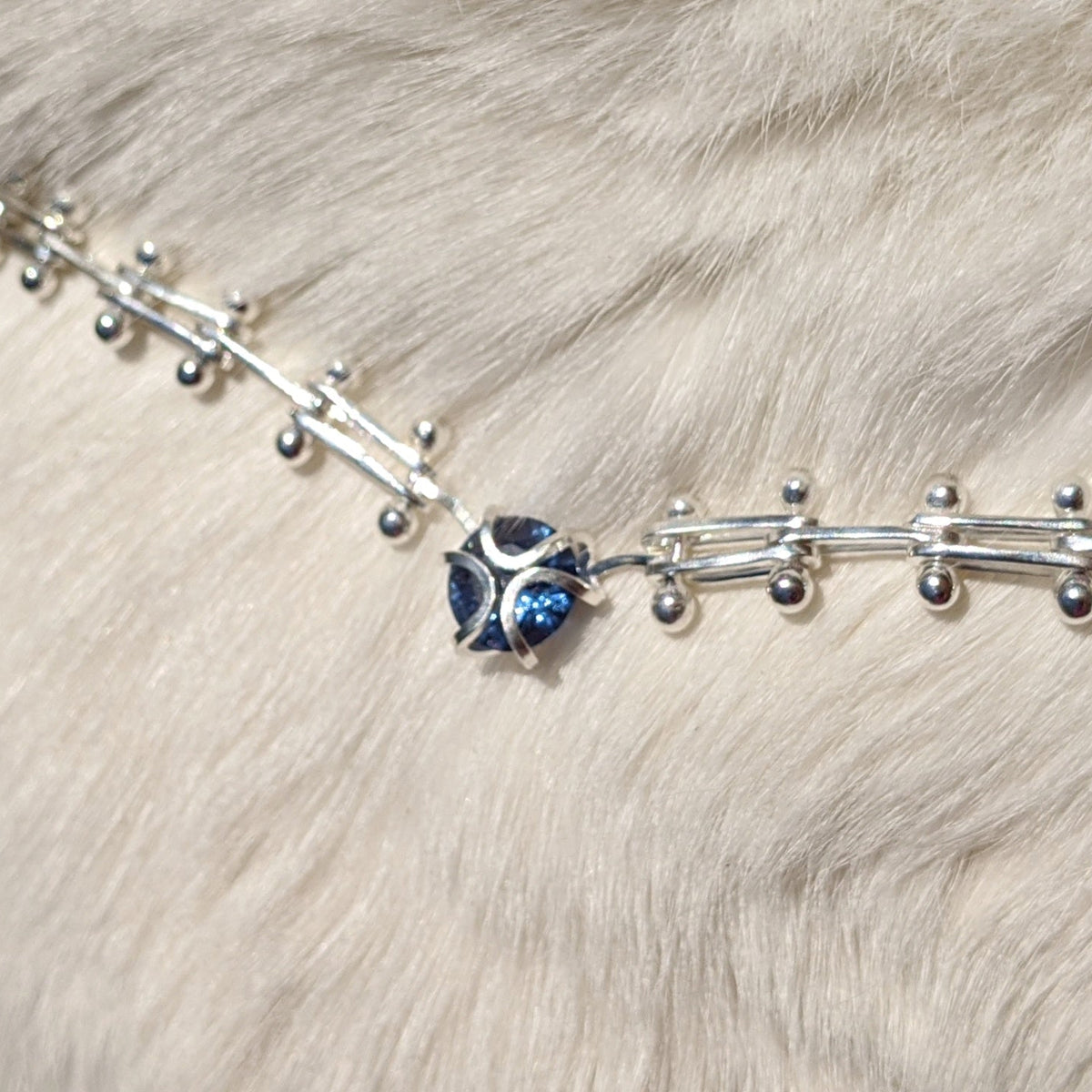Custom Bracelet with bar links and a lab grown blue zircon iris center - hand fabricated